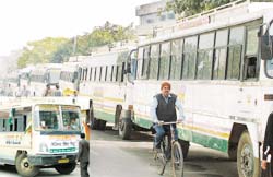 Buses engaged by candidates of the Jalandhar area lined up on the road in front of the DCs office in the city