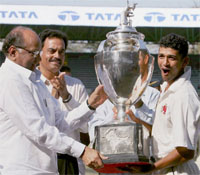 Mumbai captain Amol Muzumdar receives the Ranji Trophy from BCCI President Sharad Pawar as Chairman of the Selection Committee Dilip Vengsarkar looks on at the Wankhede Stadium in Mumbai