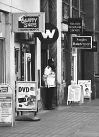 A policeman stands guard in front of a building in Victoria Street in Central London on Monday. A letter bomb exploded at an office in the heart of central London on Monday, injuring one woman employee.