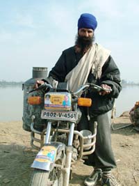 No light from this headlight: A milk-vender in Mand area has masked the headlight of his motorcycle with a poll sticker.