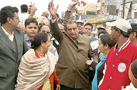Congress candidate from Ludhiana West Harnam Dass Johar waves to his supporters during a campaign in Ludhiana on Friday.