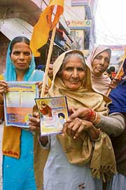 SAD supporters distribute pamphlets of Guru Ravi Dass during a march taken out by party nominee Mohan Lal in Banga on Friday. 