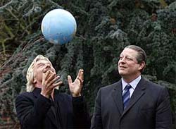 Airline tycoon Richard Branson (left) throws a globe in the air as former US 