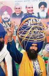 A supporter makes the victory sign during an election campaign in Amritsar 