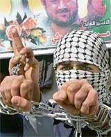 A Palestinian symbolically chains his hands during a demonstration to demand the release of Palestinian prisoners from israeli jails in Gaza City on Monday.