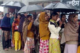 Women were not far behind their male counterparts in casting their votes. Despite the rain, the chill and soggy ground conditions they came to the polling booths in large numbers