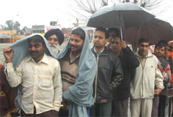 Voters wait patiently outside a polling booth in Jalandhar