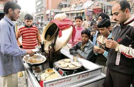 A rehri owner at Bhadaur House sells eatables on the congested road causing inconvenience to the general public and commuters.