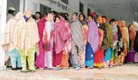 Women queue up in large numbers to vote at Kullewal village despite heavy rain on Tuesday.