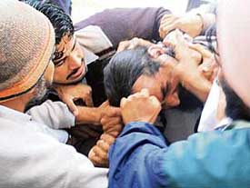 Supporters of the SAD and the Congress clash outside a polling booth in Badal village on Tuesday