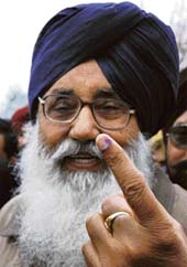 Former Chief Minister Parkash Singh Badal shows his ink mark at his native village Badal