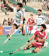 Shakeel Abbasi of Hyderabad Sultans (right) attempts a reverse hit in the goal area as Dilip Tirkey of Orissa Steelers jumps to stop the ball during Premier Hockey League at the Sector 42 Stadium in Chandigarh