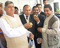 Late MLA Relu Ram Punia's brother, Mr Ram Singh Punia, distributes sweets following award of the death penalty to Sonia and Sanjeev by the Supreme Court, in the court complex in Hisar on Thursday.