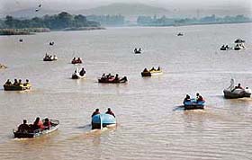 After remaining indoors due to heavy rain people throng Sukhna Lake to enjoy boating in the sunny weather