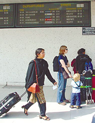 Passengers waiting for their flight at IGI Domestic Airport in the Capital on Saturday. Many flights were cancelled or diverted due to fog.