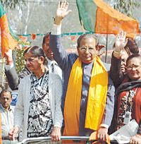 BJP leader Jagdish Mukhi with party activists at a rally at Janak Puri in the Capital on Friday.