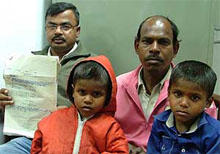 The rescued children, Krishan and Krishna, with their father, Devi Lal, and an officer-bearer of an NGO, Mr Sanjay