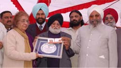Afzal Tausif, a Pakistani writer, (left) being honoured at a function organised by the Denmark-based Asian Writers Association at Simbli village, near Nawanshahr, on Saturday