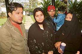 Ms Nusrat Jehan and her husband, Mr Rehan Mohammad, with co-passengers of Sada-e-Sarhad bus react to train blasts during a halt at Magnolia Tourist Complex in Kartarpur