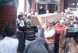 A coffin being loaded on a truck at the civil hospital in Panipat on Wednesday to be sent to the Wagah border. 
