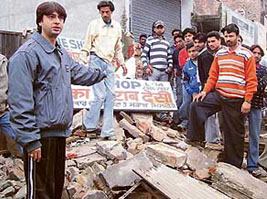 Shopkeepers protest against the demolition of shops by the Improvement Trust in Pathankot on Wednesday.
