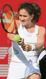 Patty Schnyder of Switzerland returns the ball to Alicia Molik of Australia during their match at the Dubai Duty Free Open tennis tournament on Wednesday. Schnyder won 4-6, 6-2, 6-4.