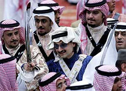 Saudi Prince Al-Walid Bin Talal Bin Abdul Aziz al-Saud (C) takes part in the traditional Arda dance (war dance) during the Janadriyah Festival of Heritage and Culture in Riyadh 