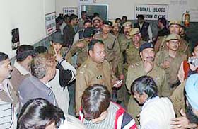 Karnal superintendent of police Sibash Kabiraj is seen with media persons and onlookers while trying to detect a bomb inside the civil hospital building in Karnal