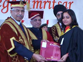 The Acting Chairman National Human Rights Commission hands over a degree to a student during the 49th convocation of DAV College