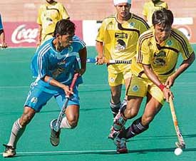 Sher-e-Jalandhars Gagan Ajit Singh (right) gets past a Chennai Veerans player during the PHL match at the Sector 42 Hockey Stadium in Chandigarh on Friday. The Shers won 6-0