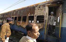 Commissioner of Railway Safety, Diwana, Bhupinder Singh and other police officials inspect the boggies of the Samjhauta Express that went up in flames after the twin blasts near Panipat on Saturday. 