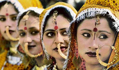 Carrying the heavy burden of nose-rings, these folk dancers await their turn at the Rose Festival