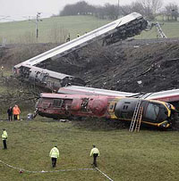 Police officers stand near the Virgin Pendalino train that derailed on the west coast main line near the village of Grayrigg near Kendal in the Lake District, north-west England, on Saturday.