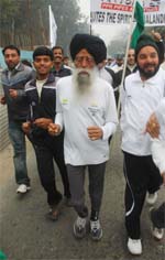 Baba Fauja Singh (centre) oldest marathon runner in the world takes part in half marathon in Jalandhar on Sunday.