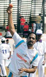 Actor Nana Patekar bowls during a cricket match between UTVs Hat-trick-11 and Fedex-11 in Mumbai on Sunday