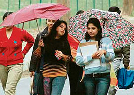 Intermittent rain forced these Panjab University students to open their umbrellas in Chandigarh