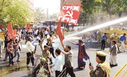 Policemen using water cannons to disperse protesting CPM activists at Jantar Mantar in the Capital on Tuesday. The protest was against the rising prices of essential commodities. 