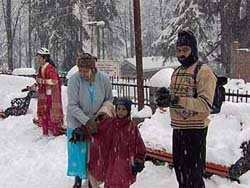 Tourists enjoy the seasons first snowfall at Nehru Park in Manali on Tuesday.