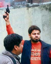 A BJP activist fires into the air to celebrate the party’s victory at the BJP office in Amritsar
