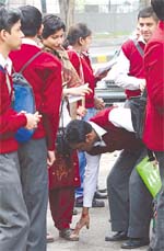 Bless me, maam: A student touches the feet of his class teacher on the first day of the class