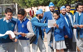 Students discus their question paper out side an examination centre in Jalandhar as CBSE examinations began on Thursday.