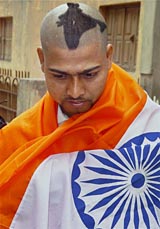 Sharun Sharma, a die-hard cricket fan, shows his Indian map hairstyle in Jamshedpur on Thursday. Sharun says he can go to the extent of selling one of his kidneys to go to the West Indies for the World Cup.