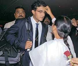 A woman applies tilak on the forehead of Sourav Ganguly in Mumbai on Wednesday night, prior to the teams departure for the West Indies for the cricket World Cup.