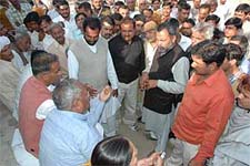 Acting president of the Haryana Pradesh Congress Committee Ram Parkash talks with residents of Saalwan village in Karnal on Friday