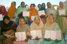 Residents show their ration cards with fake entries marked by the depot owner in Khotran village in Nawanshahr district on Friday
