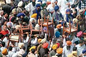 Party faithful carry their own chairs at the huge swearing-in ceremony.