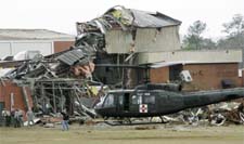 A US military helicopter evacuates an injured person from Enterprise High School after a tornado did severe damage to the school, on Thursday, in Enterprise, Alabama. 