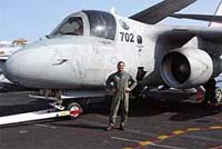 Pakistani-born Mohammed Khan poses for a picture in front of his aircraft on board the USS John C. Stennis in the Gulf of Oman off the coast of Pakistan