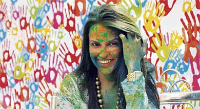 Actress Neha Dhupia smiles after celebrating Holi with schoolchildren