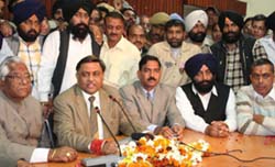 Cabinet minister Manoranjan Kalia (second from left) addresses mediapersons in Jalandhar